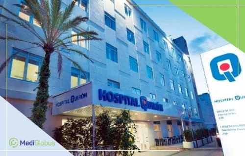 Заміна кульшового суглоба в Іспанії — лікування в клініці Hospital Quirón Сучасна будівля лікарні Hospital Quirón з пальмою біля входу