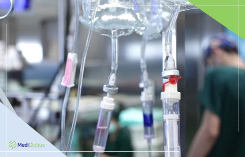 медичні крапельниці з розчинами, підвішені на стійці в клінічних умовах
