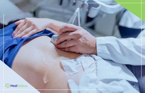 УЗД-діагностика — безпечний та інформативний метод візуалізації внутрішніх органів Лікар проводить ультразвукове обстеження пацієнта, який лежить на кушетці; рука фахівця в білому халаті тримає датчик, на який нанесено гель для поліпшення контакту; на тлі видно частину живота пацієнта та обладнання для УЗД